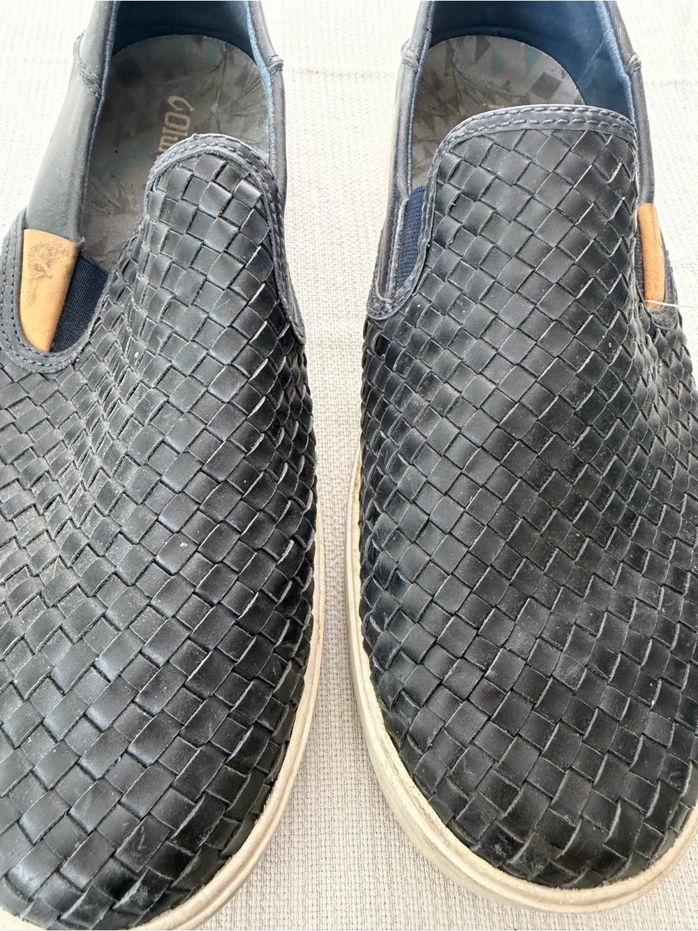 OluKai Men's Woven Slip-On Loafers in Black with Tan Accents
